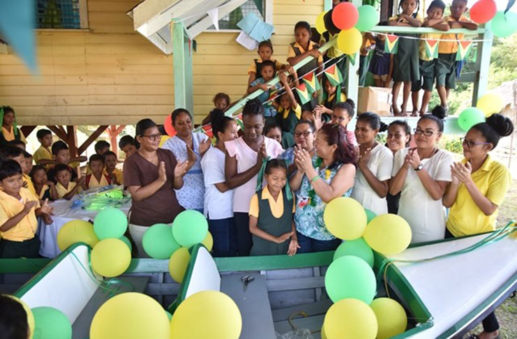 Minister Hastings-Williams handing over the boat to the village’s leaders