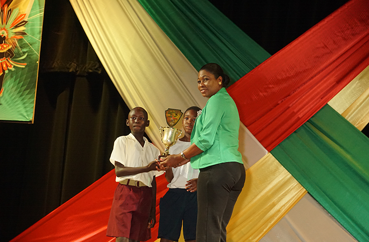 Pupils of the St. Andrew’s Primary School receiving their first place trophy for their masquerade performance