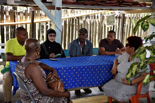 Minister of Social Protection Amna Ally (right) during the visit to the home of the Azeez family in Bush Lot, Region 5.  MP Jennifer Wade is seated extreme left.