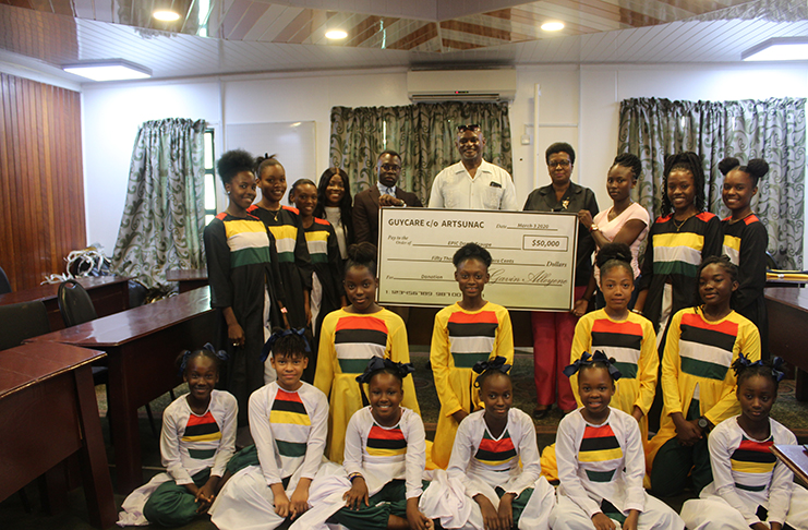 NGO Representatives Rodwanicia Kennedy (fourth left); one of the founders of the Centre for Guyanese Progress, Gavin Alleyne; REO, Orrin Gordon; DREO, Maylene Stephen; Dance group leader, Shannon Griffith and several members of the group, pose with the $50,000 cheque