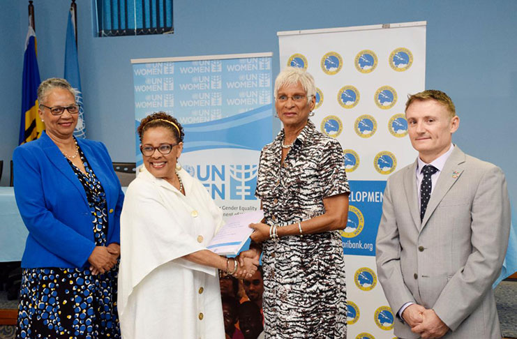 (second left) Alison McLean, Representative, UN Women Multi Country Office – Caribbean presents Ambassador Gail Mathurin, Director-General of the CARICOM Secretariat's Office of Trade Negotiations (second right) with a copy of the Compendium Knowledge Product “Caribbean Experiences with Collecting Data on Violence against Women and Girls.” Looking on are Monica La Bennett, Vice-president (Operations), Caribbean Development Bank (left) and Didier Trebucq, Resident Coordinator, UNDP, Barbados and the OECS.