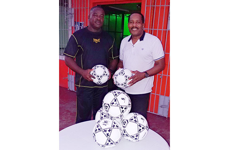 Franklin Wilson (left) and Ralph Green with the donated balls.