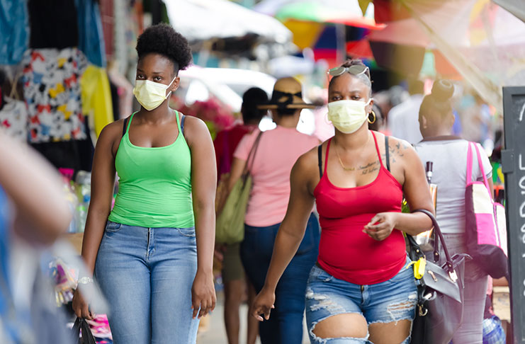 Guyanese manoeuvring through the capital city of Georgetown wearing gloves and face masks as they take precautions to prevent the spread of Coronavirus (Delano Williams Photos)
