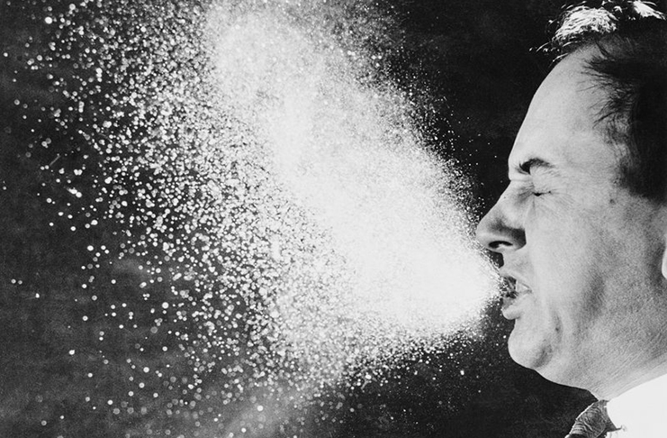 A photograph from 1940, taken for infectious research purposes at the Massachusetts Institute of Technology, shows respiratory droplets released through sneezing.