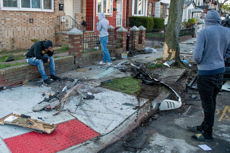 A cousin of the deceased, left, grieves at the scene Sunday morning. (Theodore Parisienne/for New York Daily News)