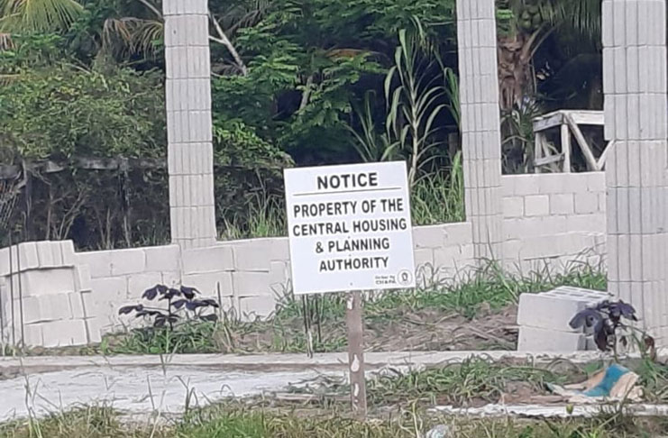 Signs erected by the Central Housing and Planning Authority on the house lot in question.