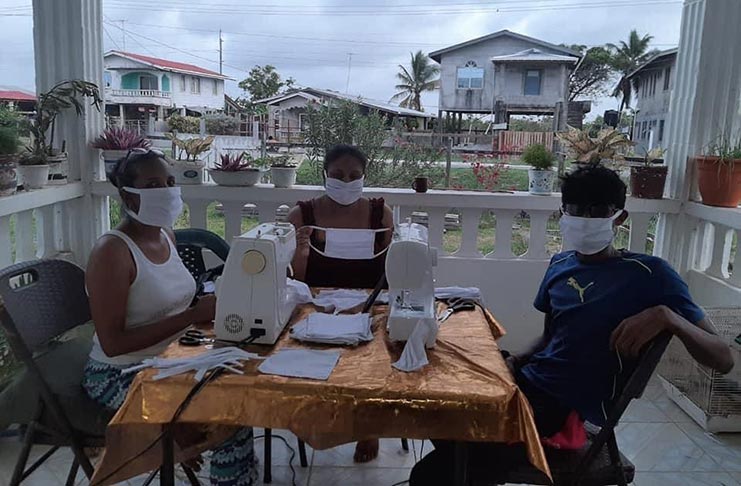 Volunteers helping to sew the masks for distribution