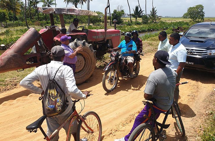 Regional Executive Officer, Denis Jaikarran, meeting with rice farmers