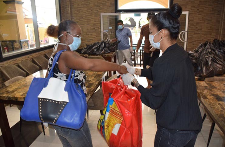 A SleepIn Hotel employee receiving her food hamper