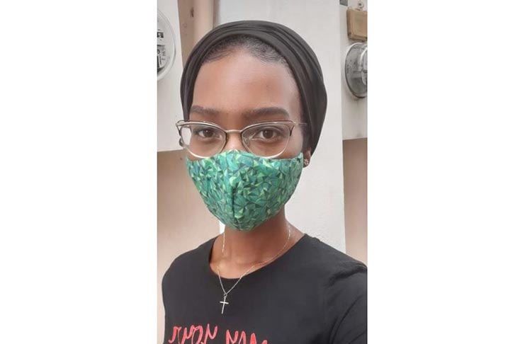 The young fashion designer, Akeisha Ayanna, wearing the first face mask she made