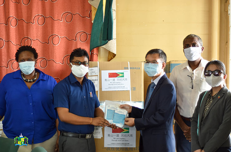 Deputy Chief of Missions and Political Counsellor, Chen Xilai, handing over the face masks to Mayor of Georgetown, Ubraj Narine, in the presence of Town Clerk (ag), Sherry Jerrick and Deputy Mayor Alfred Mentore.
