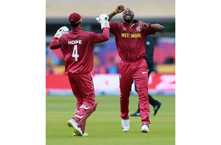 Andre Russell celebrates with Shai Hope. (Getty Images)