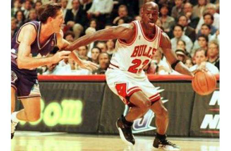 Former Chicago Bulls player Michael Jordan sticks out his tongue as he goes past Jeff Hornacek of the Utah Jazz during game two of the NBA Finals at the United Center in Chicago, IL, in this June 4, 1997 file photo. (Photo: AFP)