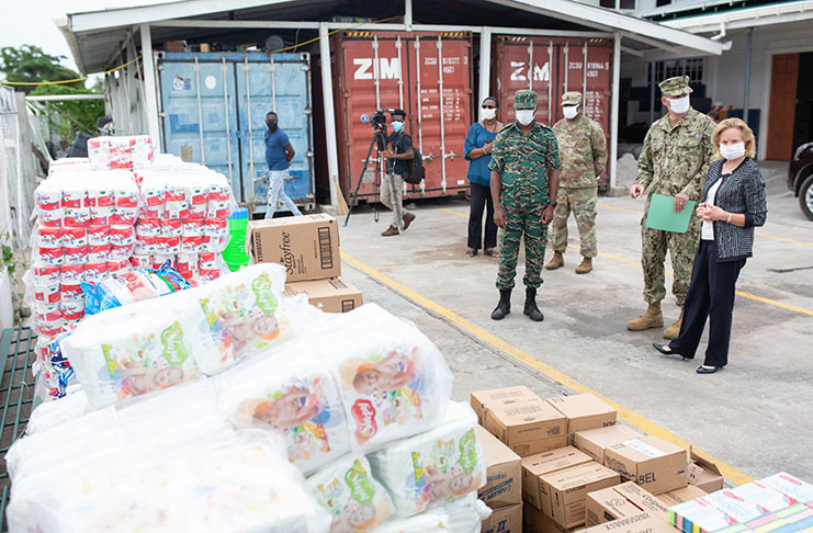 US Ambassador to Guyana, Sarah Ann Lynch and Director-General of the CDC, Lieutenant Colonel Kester Craig, inspect the supplies