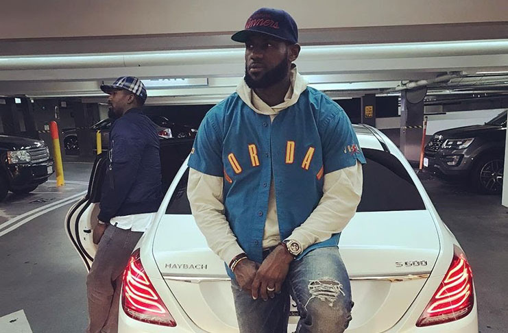 NBA superstar LeBron James poses by his luxury Mercedes Maybach S600