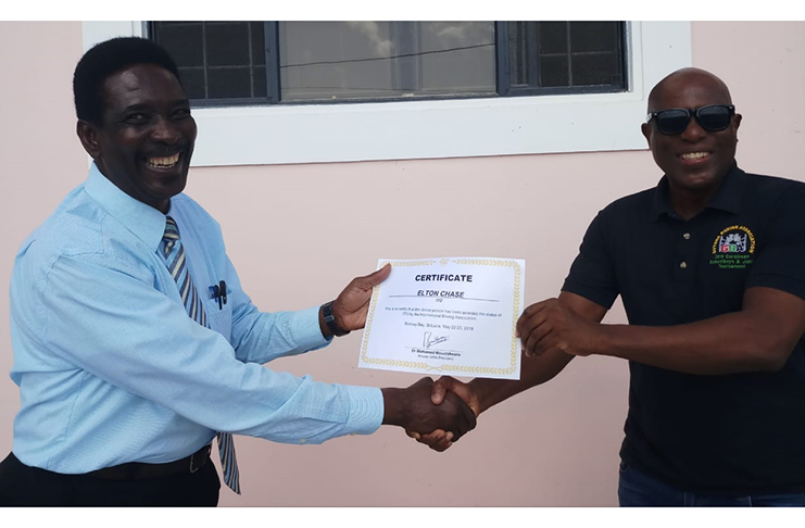 Elton Chase (left) receives the AIBA certificate from GBA president Steve Ninvalle.