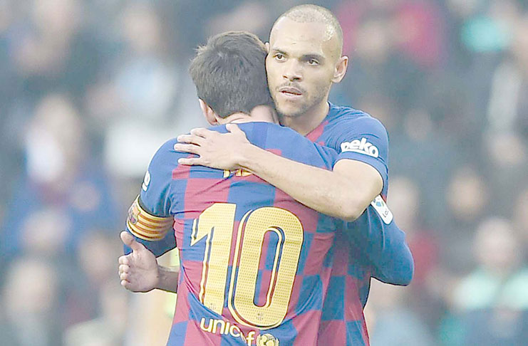 Martin Braithwaite celebrates his first goal for Barcelona with Lionel Messi.