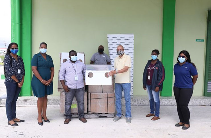 Managing Director of Courts Guyana, Clyde De Haas, presents the areoboxes to Deputy Director of the Health Emergency Operations Centre (HEOC), Dr. Leston Payne, while other officials from the Public Health Ministry and COURTS look on. (DPI photo)