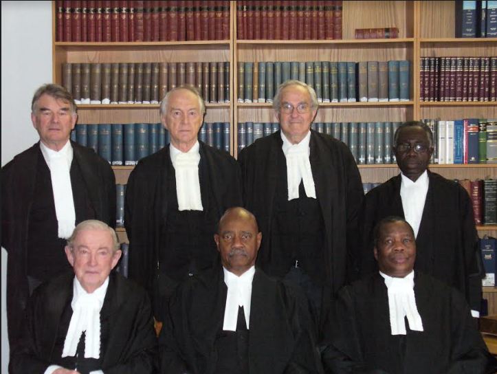 Acting as the President of the Court of Appeal of Botswana, Senior Counsel Moore, seated centre, with other judges of the court.