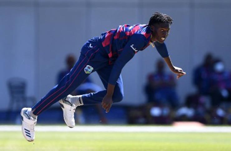 Fast bowler Chemar Holder sends down a delivery during a warm-up match at Old Trafford.