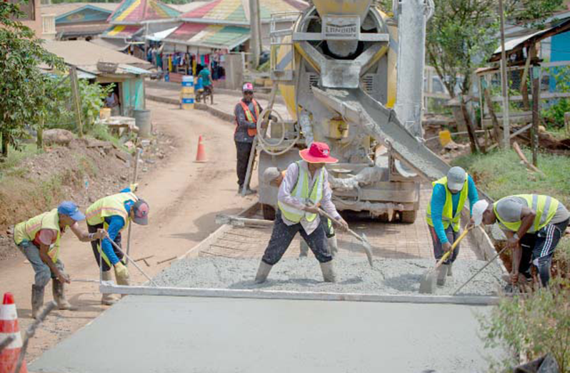 Workers compacting concrete just beyond Port Kaituma Police Station back in 2019 (DPI photo)