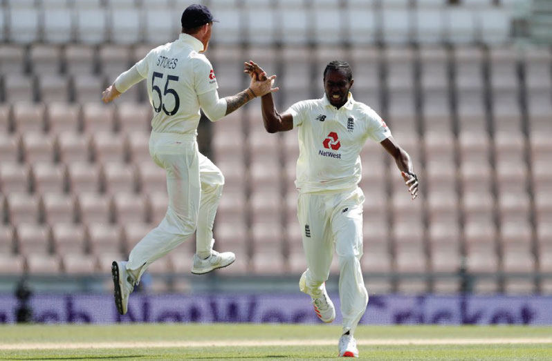 England's Jofra Archer celebrates taking the wicket of West Indies' Roston Chase with Ben Stokes, as play resumes behind closed doors following the outbreak of the coronavirus disease (COVID-19) Adrian Dennis/Pool via REUTERS