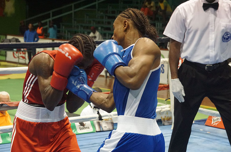 FLASH BACK! Guyana’s Keevin Allicock lands a flush right uppercut against game Trinidadian, Anthony Joseph at the Caribbean Boxing Championship. (Stabroek News/Emmerson Campbell photo)