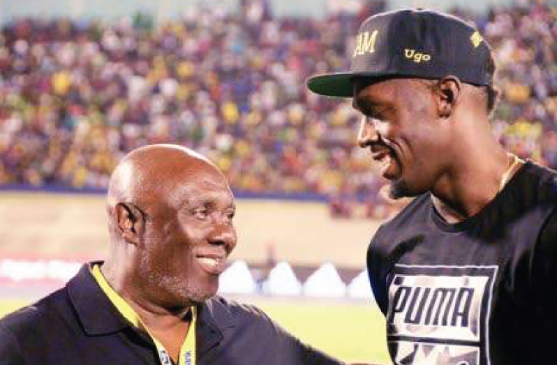 Usain Bolt (right) wih coach Glen Mills (Photo: Joseph Wellington
