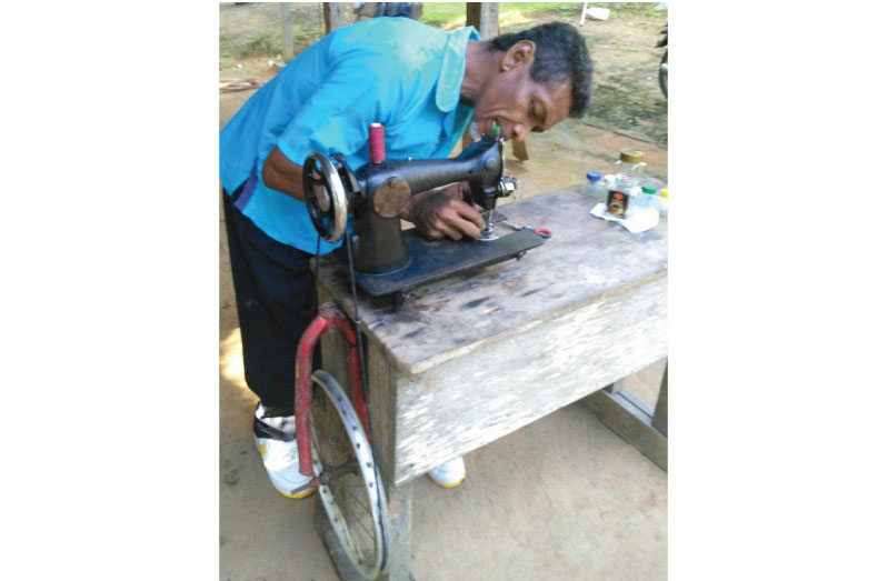 Otis Castello fixes the thread on his sewing machine