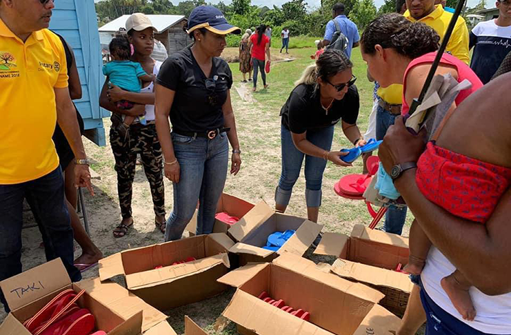 Ms. Artiga, in cap, and other Rotarians distributing care packages to Berbicians
