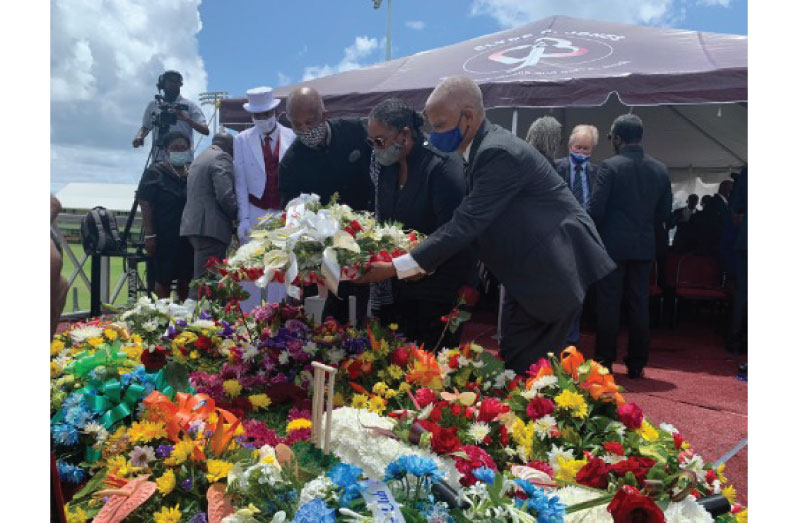 Barbados Prime Minister Mia Mottley (centre) along with Professor Hilary Beckles (left) and close friend of the Weekes family, Adrian Donovan, lay a wreath on the grave of Sir Everton Weekes.