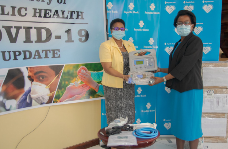 Republic Bank Representative, Denise Hobbs (right) hands over the bank’s donation of portable ventilators to Minister of Public Health, Volda Lawrence
