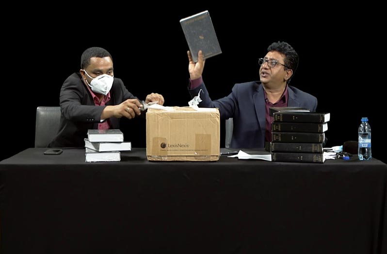 Attorney-General, Anil Nandlall, during a virtual press conference, displays his law books against those he purchased to donate to the then coalition government which was not accepted but will be donated to any State agency currently in need