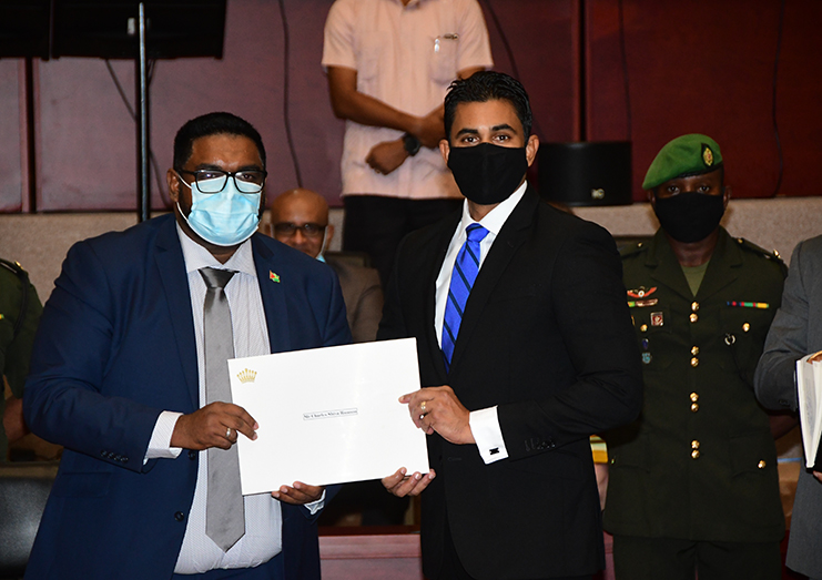 Charles Ramson Jnr. collects his instruments of appointment from H.E Irfaan Ali. (Adrian Narine Photo)