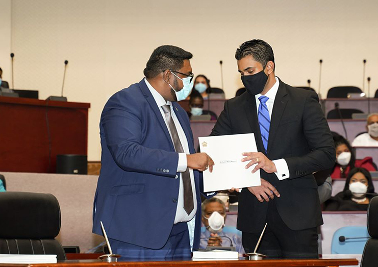  Minister of Culture Youth and Sport, Charles Ramson Jr (right), and Predident Dr Irfaan Ali, after signing his Oath of Office on August 5.