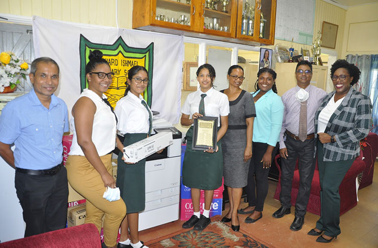 Class of 88 rep, Hemant Narine (left), Yasmin Bowman and John Tularam (right), Deputy HM Ms. Khan (4th right), along with teachers and students pose following the presentation.
