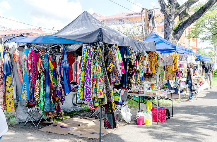 Scenes from the popular vending spot at Main Street Avenue, where vendors set up shop in hopes of making an Emancipation Day sale (Photos by Delano Williams)