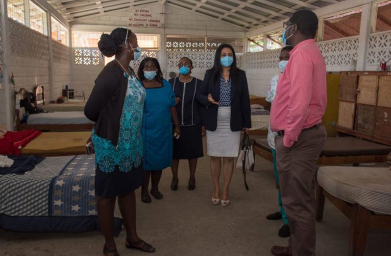 Minister of Human Services and Social Security, Dr. Vindhya Persaud and members of her fact-finding team examining one of the sleeping quarters at the Night Shelter during their visit there on Tuesday (DPI photo)