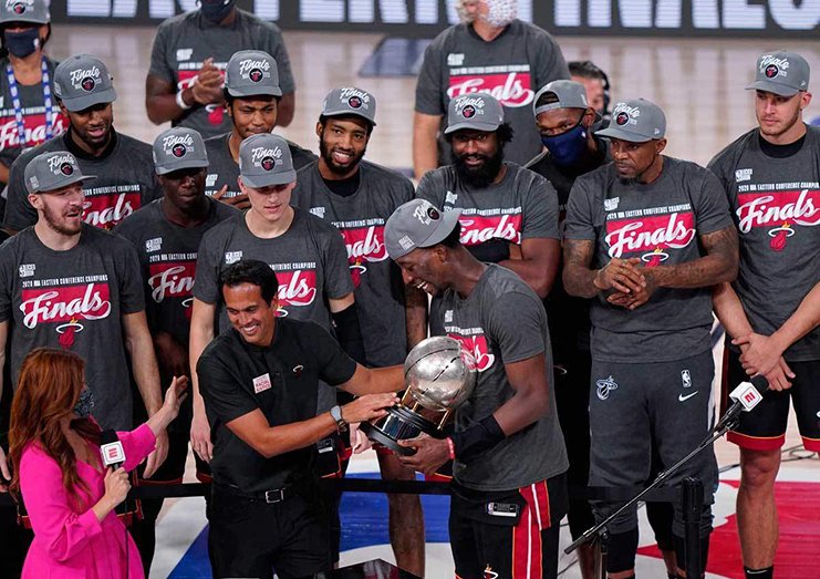 Miami Heat head coach Erik Spoelstra hands the Eastern Conference Championship trophy to forward Bam Adebayo (13) after defeating the Boston Celtics at AdventHealth Arena. Photo by Kim Klement /USA TODAY Sports