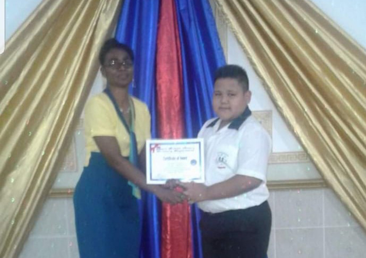 Daniel Phillips receiving an award for being the Most Improved Pupil of his school in 2017