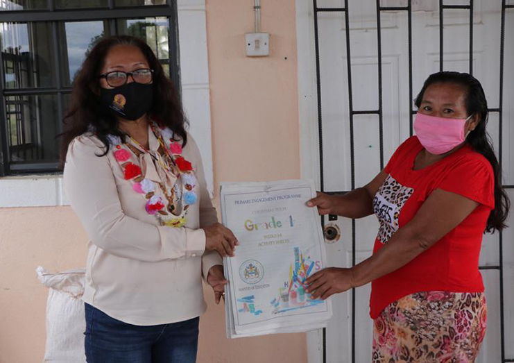 Minister Sukhai hands over learning materials to Regional Executive Officer of Region 8, Mitzy Campbell, for the Mahdia schools