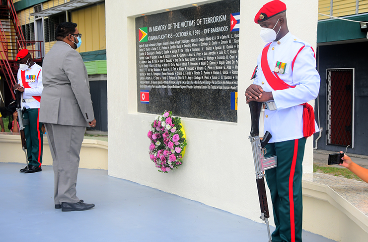 President Irfaan Ali lays a wreath at the monument erected at the Turkeyen Campus to remember the victims of the October 1976 terrorist attack – Adrian Narine Photo.