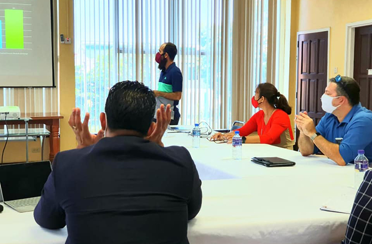 Minister of Sport Charles Ramson engages GHB executives during a PowerPoint presentation at their meeting last week. (Photo compliment: Ministry of Culture, Youth and Sport)