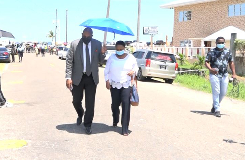 PNCR Chairperson Volda Lawrence and her attorney, Nigel Hughes heading into CID Headquarters on Tuesday