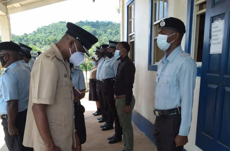 Outgoing Commander of Region One, Senior Superintendent Jairam Ramlakhan inspecting the attire of ranks at the Matthews Ridge Police Station