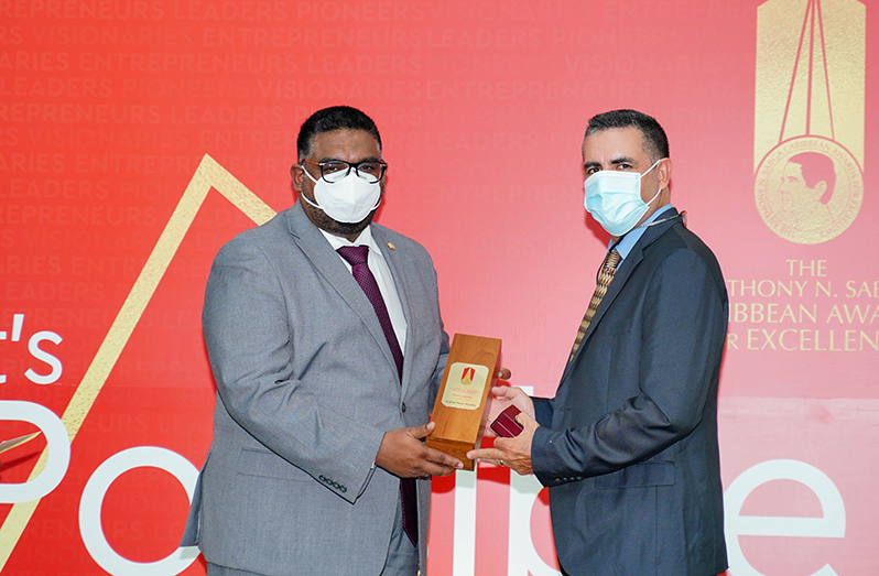 President Irfaan Ali bestows the Anthony N Sabga Caribbean Award for Excellence in Entrepreneurship upon well-known Guyanese businessman, Andrew Mendes (Office of the President photo)