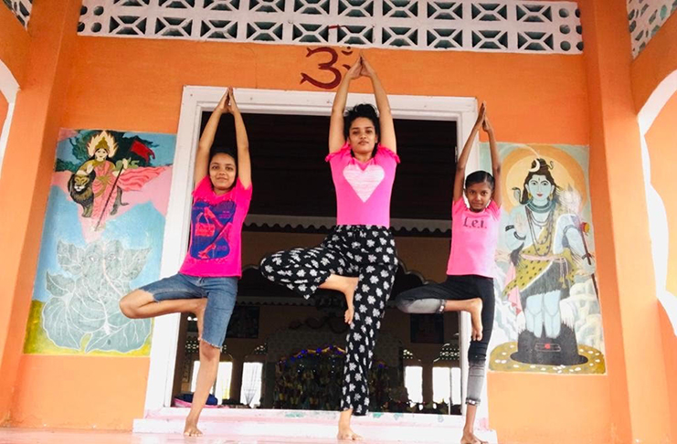 Seeta Dalloo and two of her yoga students practising the Vrksasana (Tree Pose).