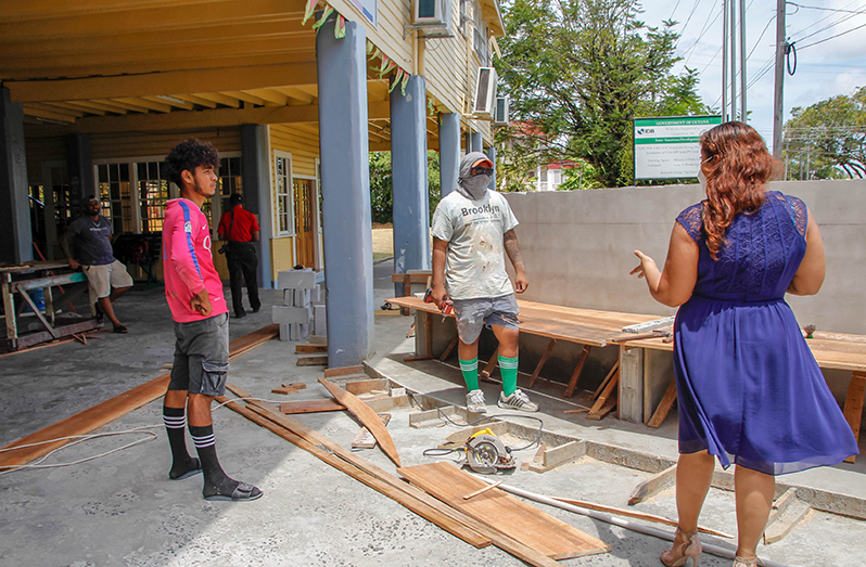 Education Minister, Priya Manickchand (right) speaking with contractors carrying out works at the Bishops’ High School on Tuesday