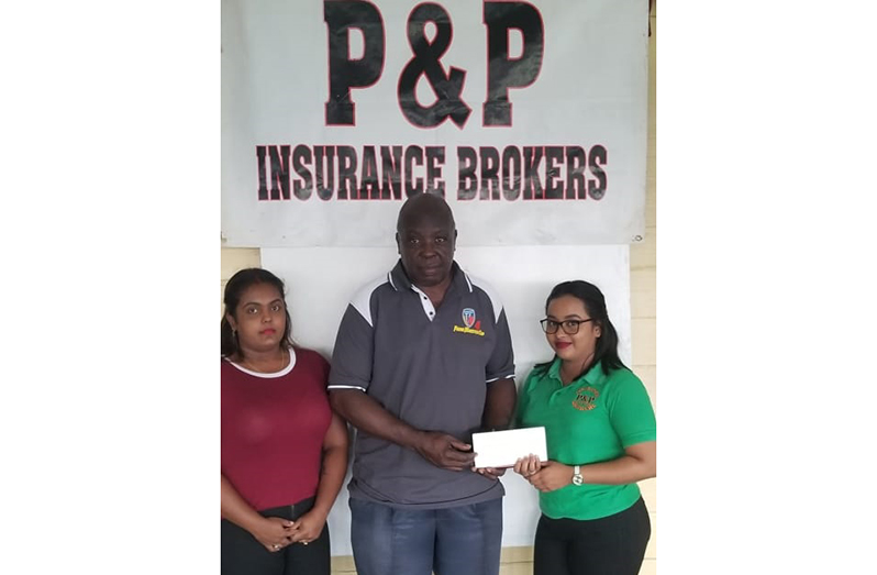 From left, P&P Insurance staff representatives Dhavina Bisnauth, GSCL president Ian John (centre) receive the sponsorship check from Anupa Lall. (Clifton Ross photo)