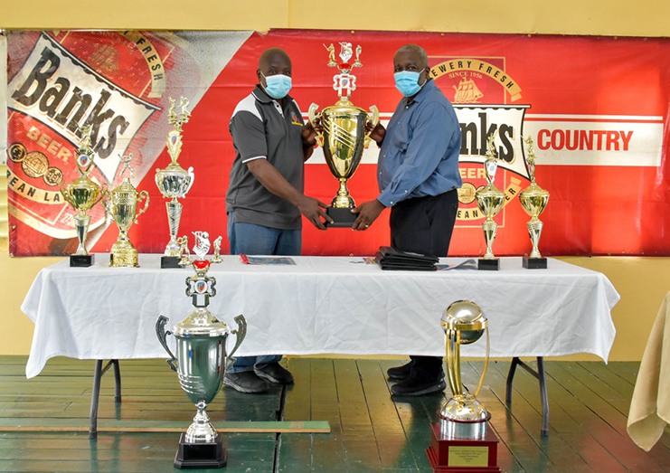 Prime Minister, Brigadier (ret’d) Mark Phillips (right) and President of the Georgetown Softball Cricket League Inc., Ian John with the trophies up for grabs.
